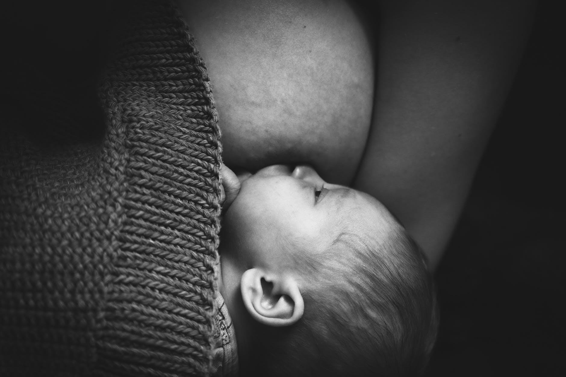 mother breastfeeding newborn baby