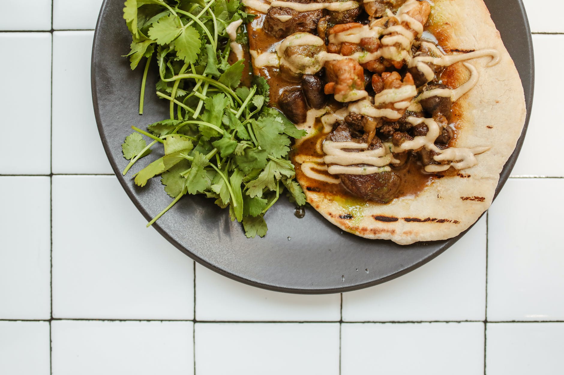 a curry dish over a roti bread