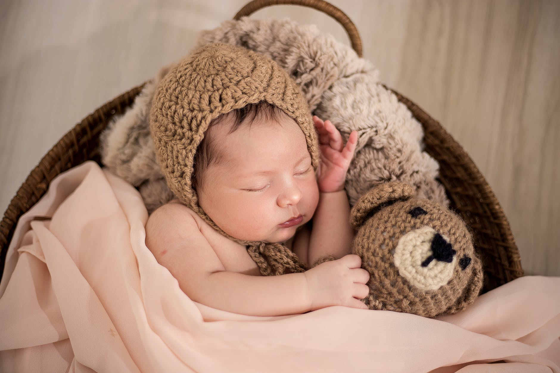 baby wearing brown knit cap while sleeping