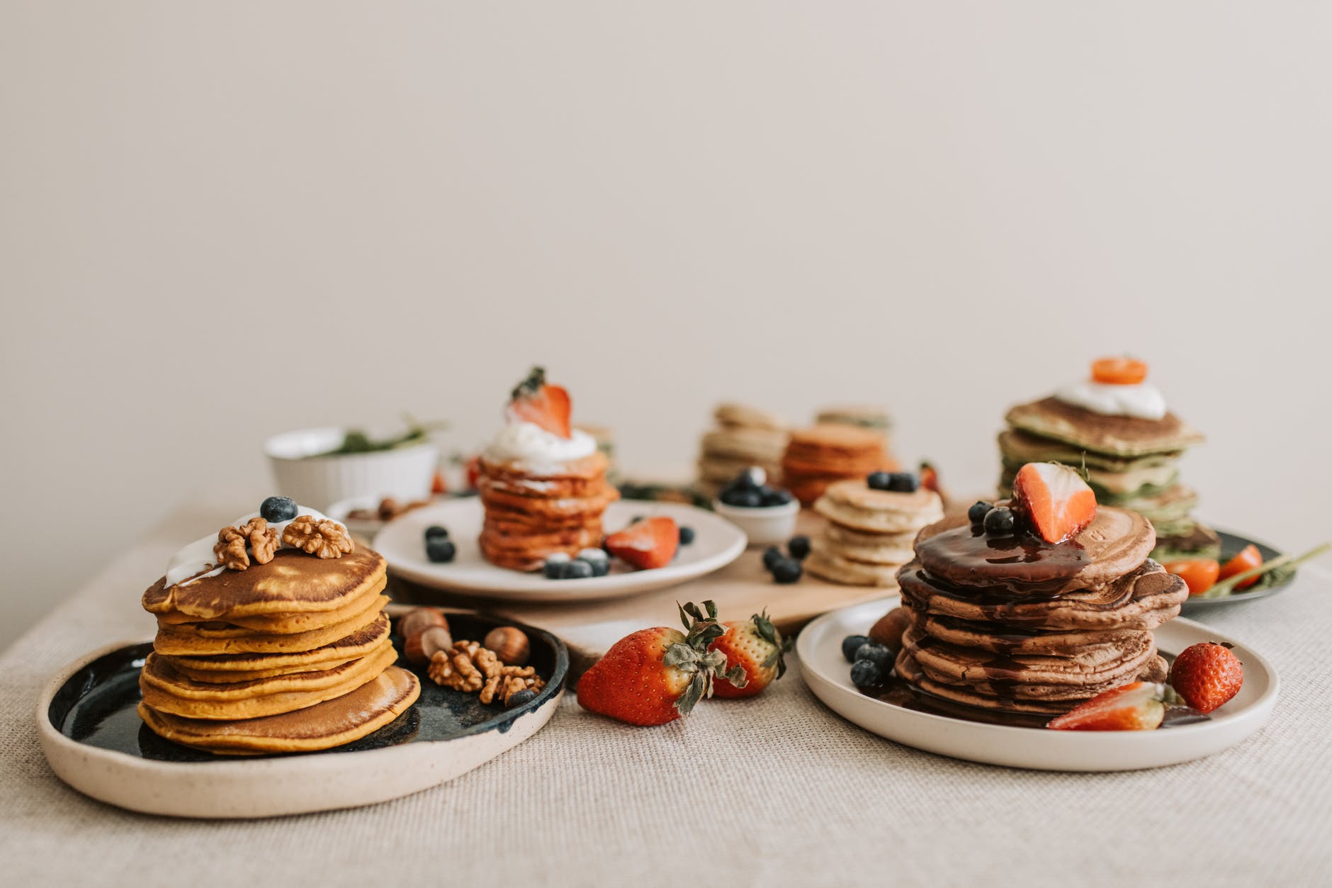 close up shot of delicious pancakes with berries and nuts