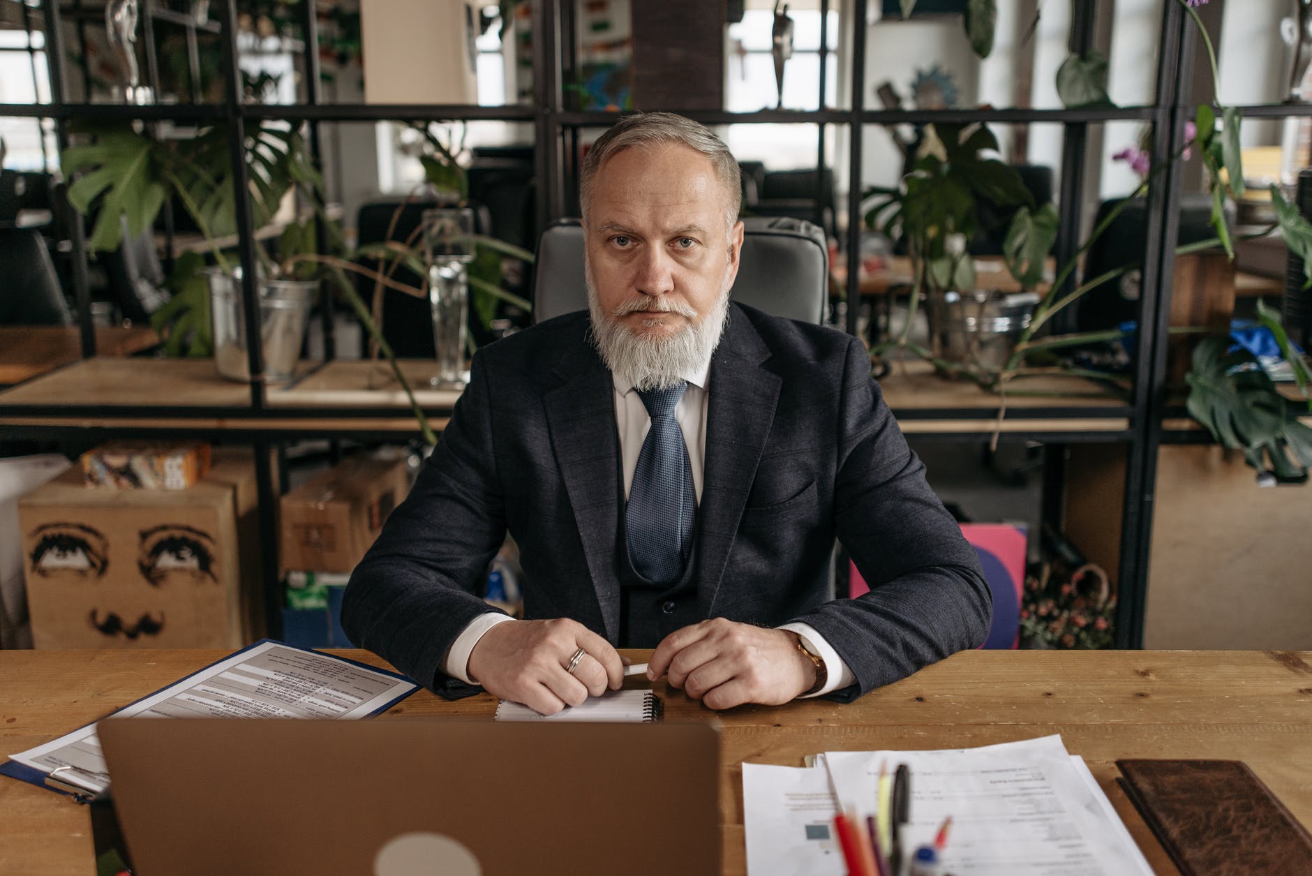 man in black suit jacket sitting at the table