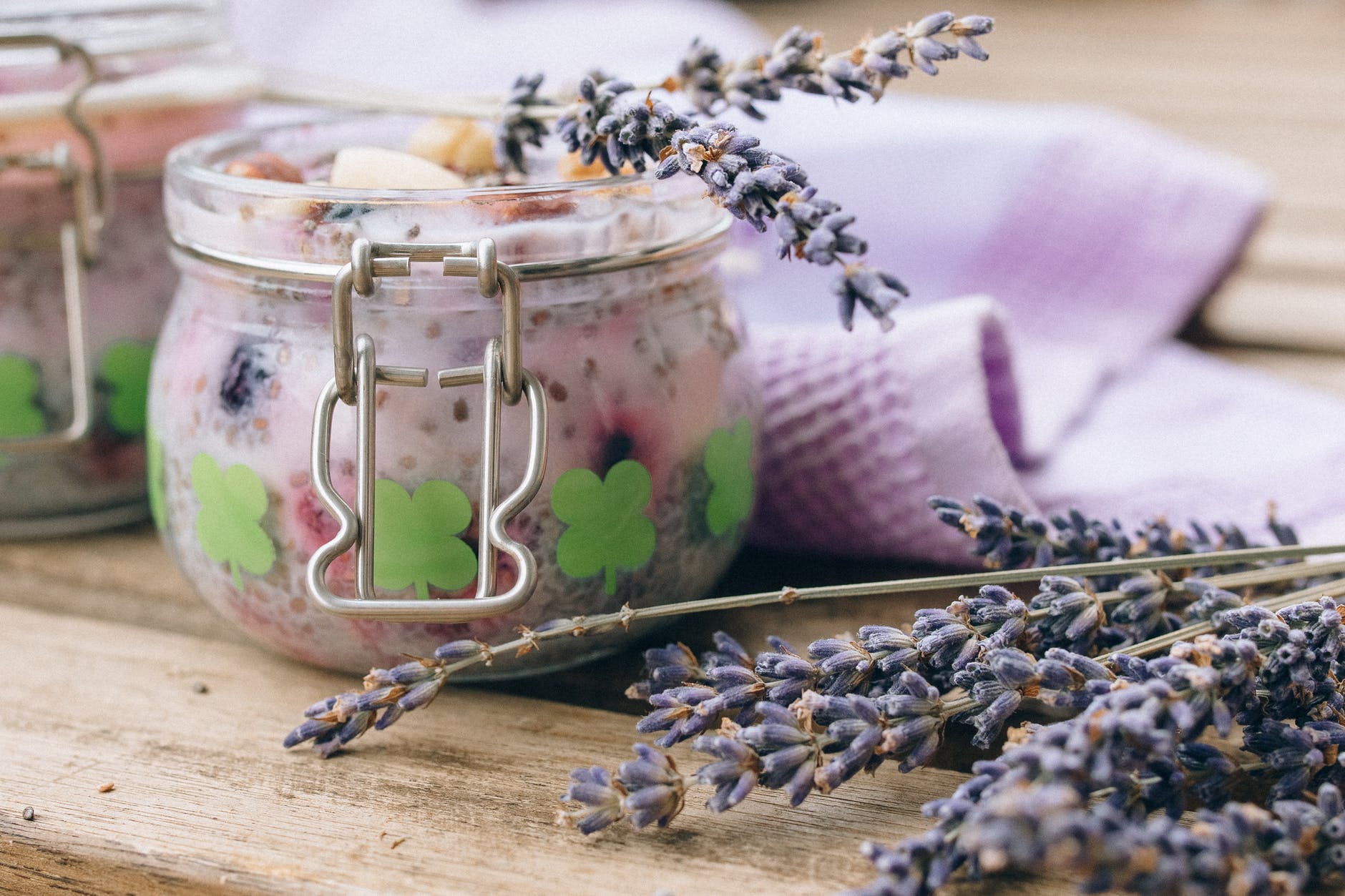 clear glass container on white textile