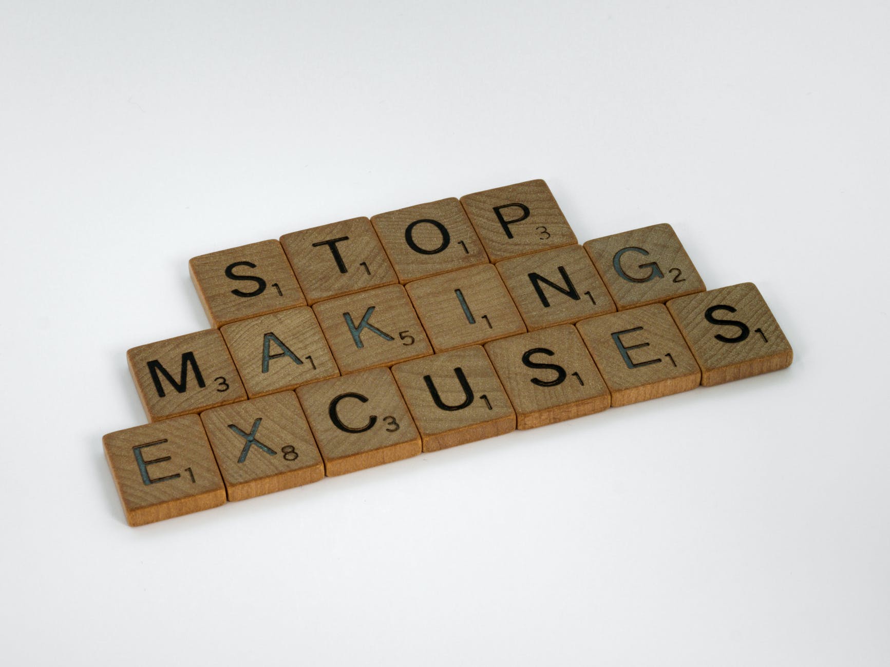 close up shot of scrabble tiles on a white surface