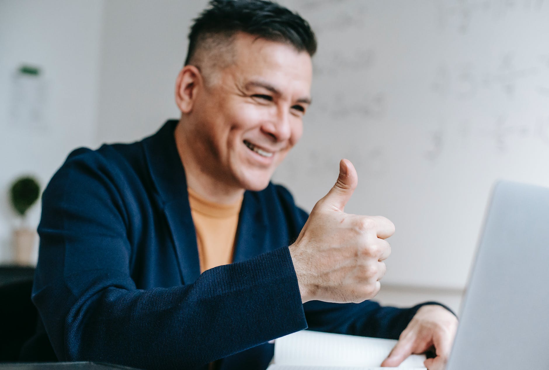 photo of man doing thumbs up hand gesture
