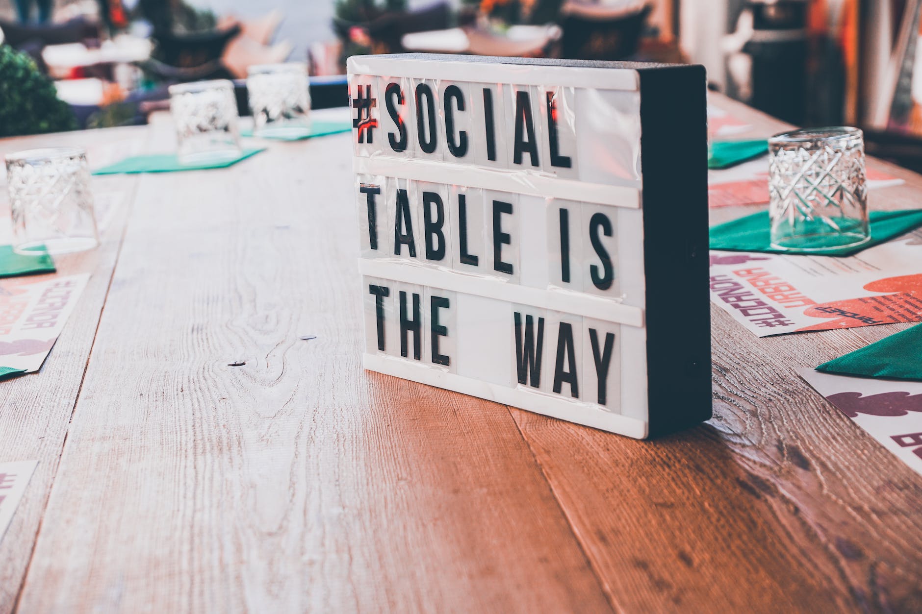 white and black signage on top of a wooden table