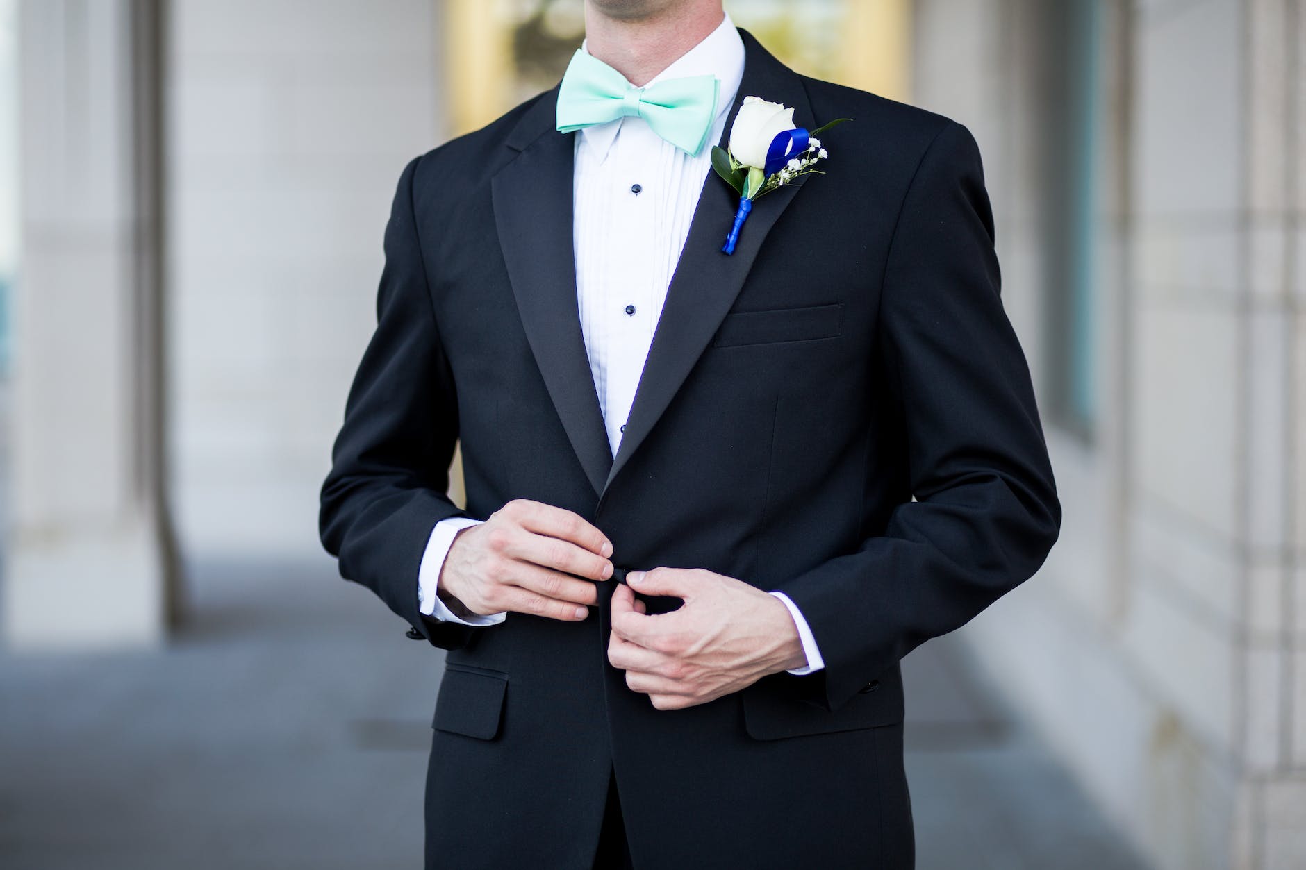 man wearing black and teal tuxedo