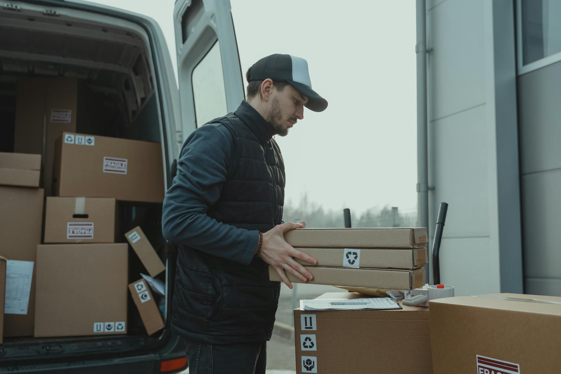 man checking the paper while carrying the packages